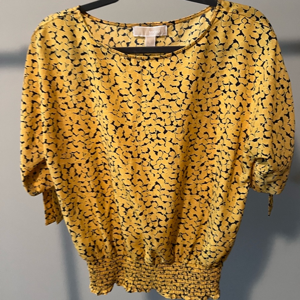 Yellow top with embellished sleeve and fitted waist.